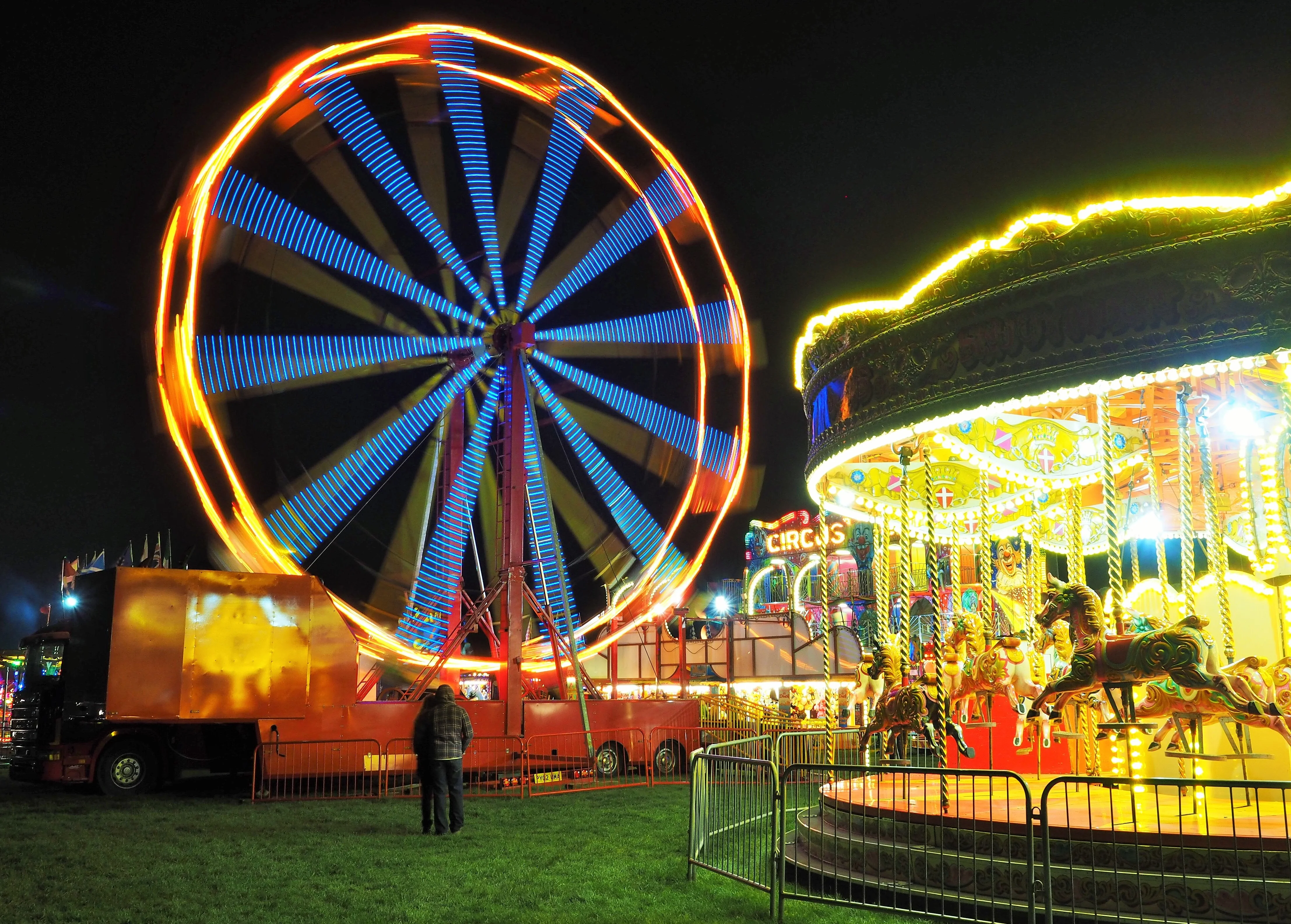 Ferris wheel and carousel at night